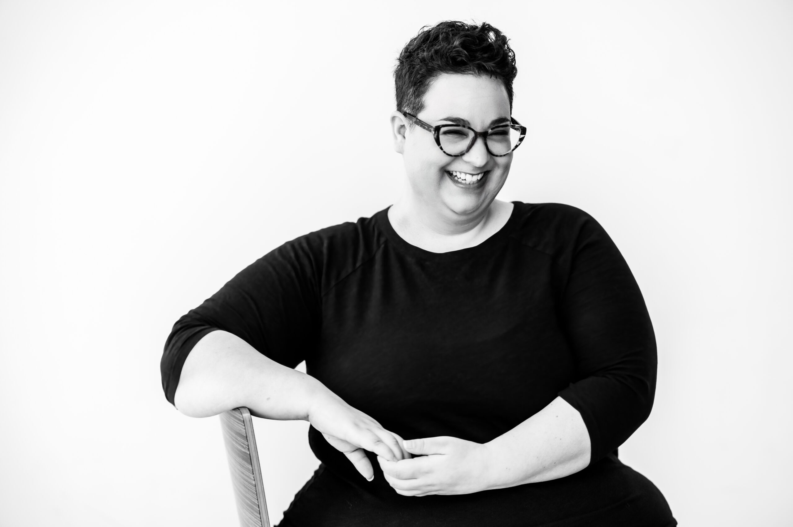 [photo] Ophira Calof sitting in a chair and smiling